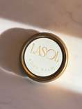 Load image into Gallery viewer, Jar of LASOL body balm on a marble surface
